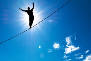 Man balancing on trapeze wire. Balance.